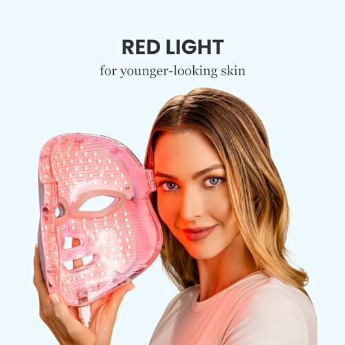 Woman holding a red light therapy mask for skin care, demonstrating the convenience and portability of the Pure Daily Care Luma Mask LED Skincare Device for the Face